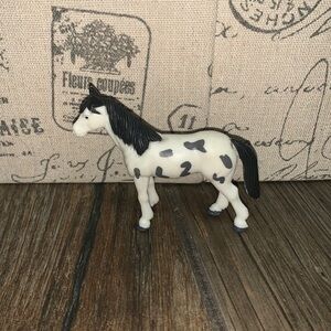 A black and white paint horse with a black mane and tail